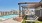a pool with lounge chairs and a view of a city