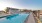 a swimming pool with chairs around it
