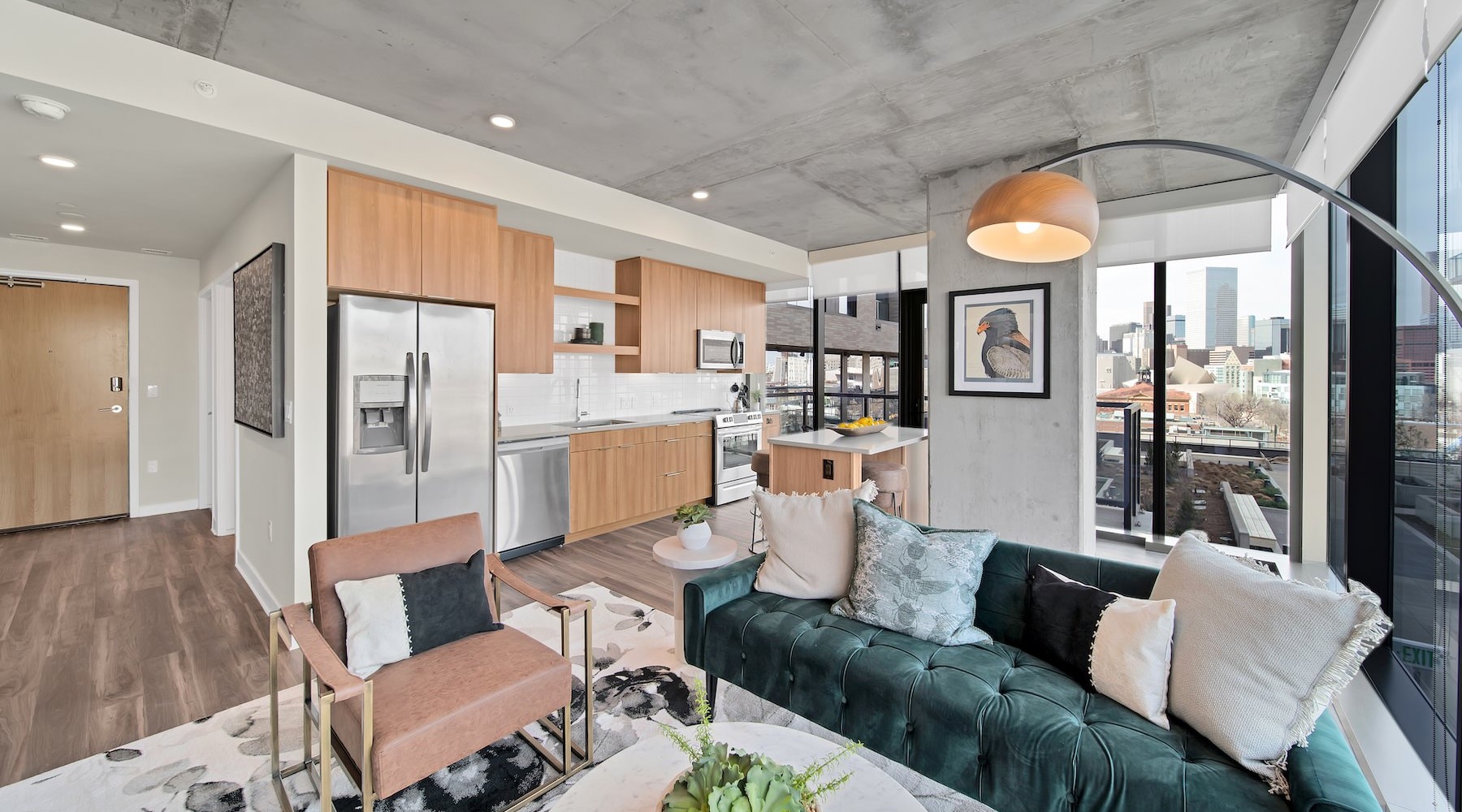 Generous living spaces to relax and unwind living room with couch lamp and large windows