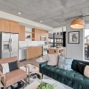 living room with couch lamp and large windows
